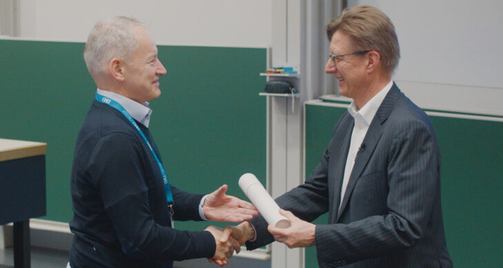 Didier Cossin, Director of the IMD Global Board Center, shakes hands with a board diploma graduate - IMD Business School