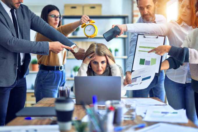 Group of business workers working together. Partners stressing one of them at the office